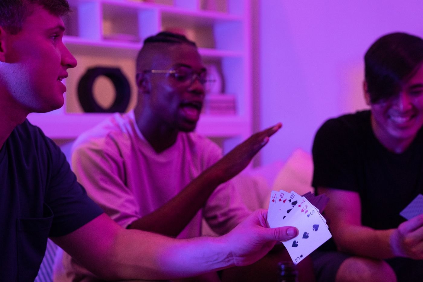 Players discussing a move while holding cards