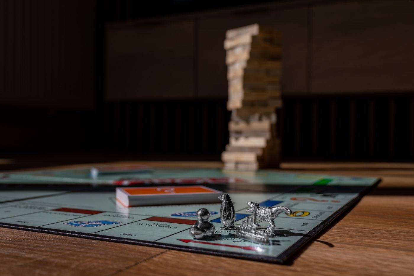 A wooden stacking tower beside a game board