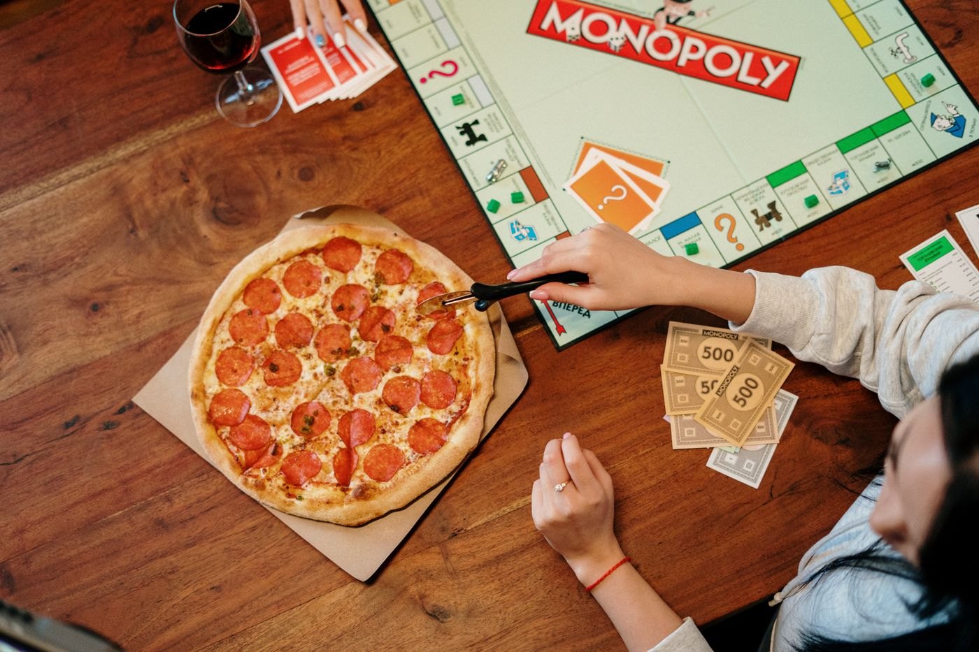 A board game set out beside pizza and drinks