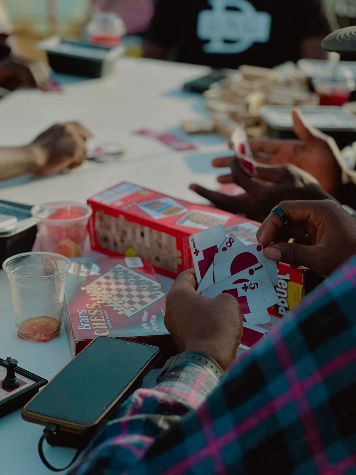 People playing cards around a shared table