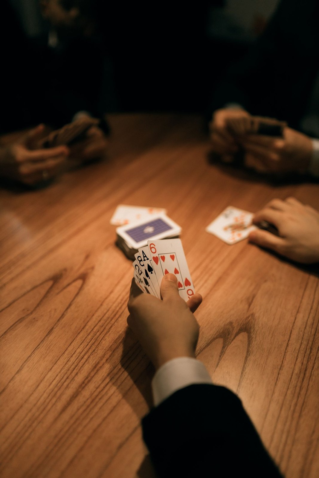 Cards held close to a player at a shared table