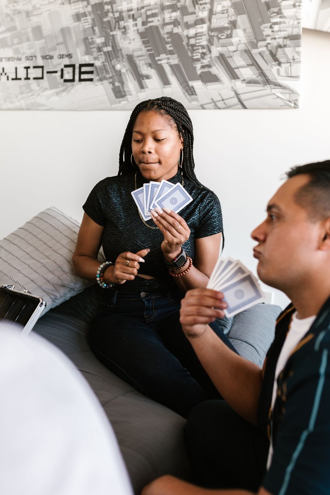 People facing one another with cards in their hands